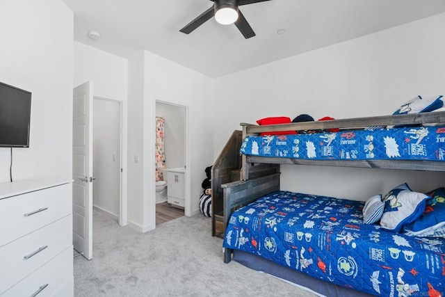 carpeted bedroom with ceiling fan and connected bathroom