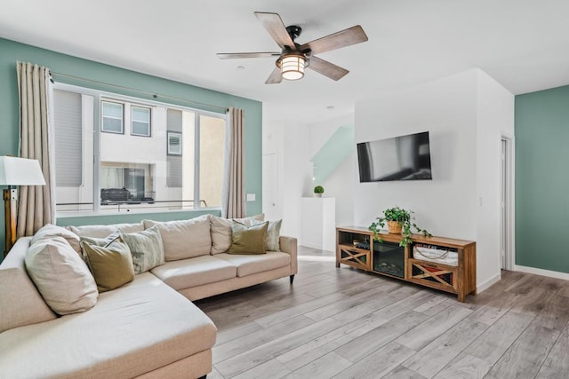 living room featuring ceiling fan and light wood-type flooring