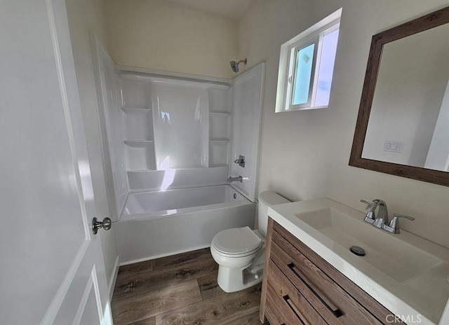 full bathroom with hardwood / wood-style floors, vanity, toilet, and shower / washtub combination