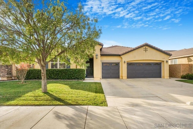 view of front of home featuring a garage and a front lawn