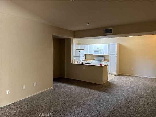 interior space featuring white cabinets, white appliances, light colored carpet, and sink