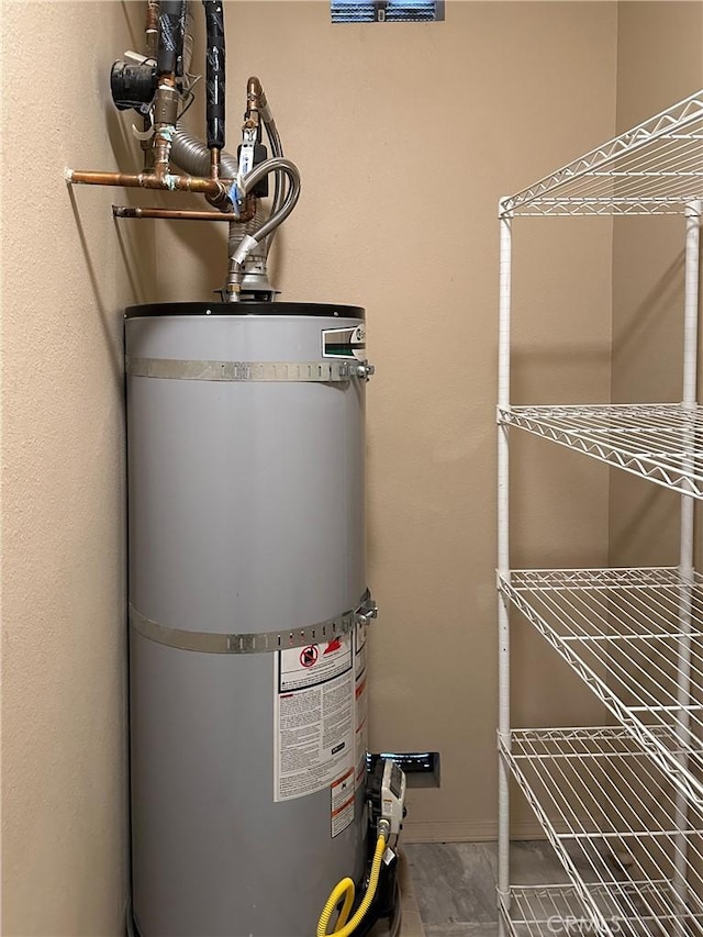 utility room featuring water heater