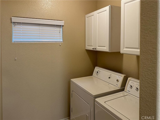 laundry area with cabinets and separate washer and dryer