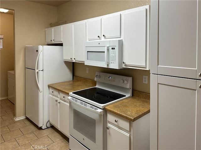 kitchen with white cabinetry, light tile patterned flooring, and white appliances