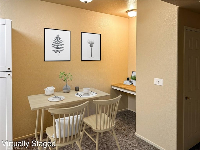 dining room with dark carpet