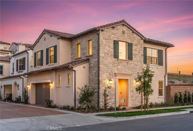 mediterranean / spanish house with a garage