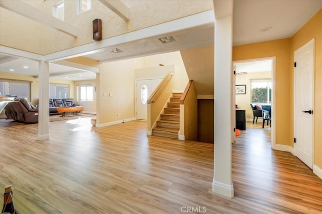 living room featuring light wood-type flooring and a wealth of natural light