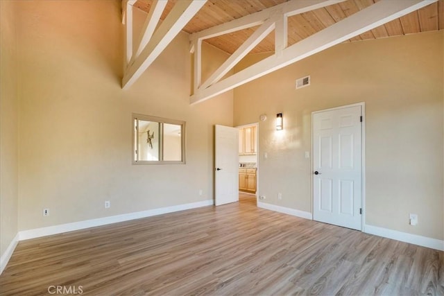 interior space featuring beam ceiling, wood-type flooring, wooden ceiling, and high vaulted ceiling