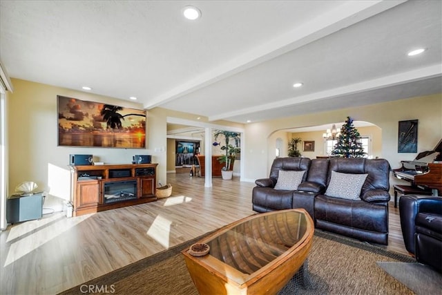 living room with beamed ceiling and hardwood / wood-style floors