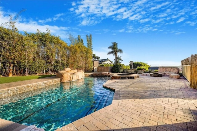 view of pool featuring an in ground hot tub and a patio area