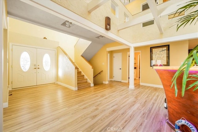 entrance foyer featuring hardwood / wood-style flooring and beam ceiling