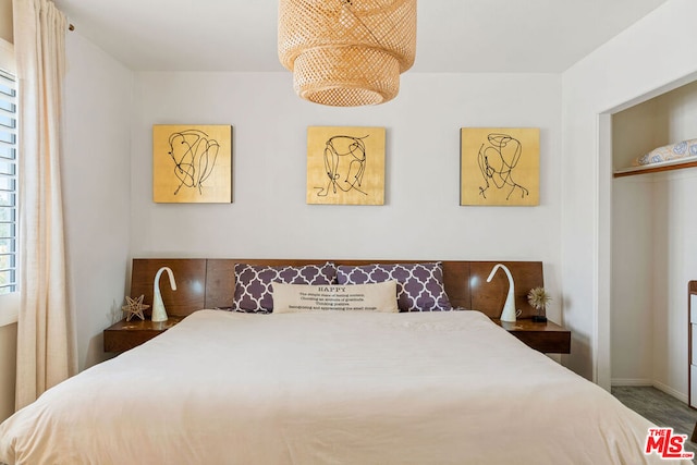 bedroom with hardwood / wood-style floors and a closet