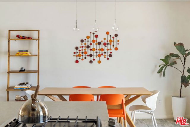 dining space with hardwood / wood-style flooring