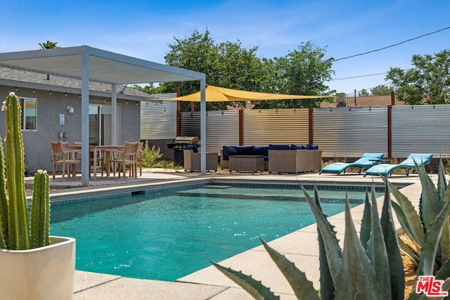 view of swimming pool featuring an outdoor living space and a patio area