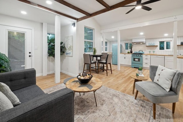 living room with vaulted ceiling with beams, ceiling fan, and light hardwood / wood-style flooring