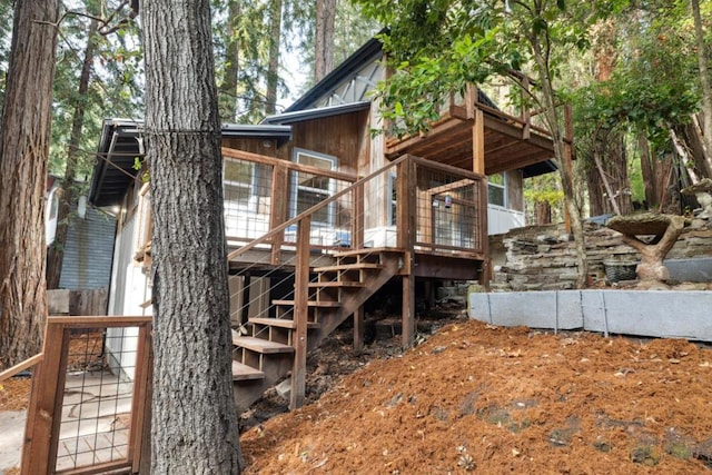 back of house with a wooden deck