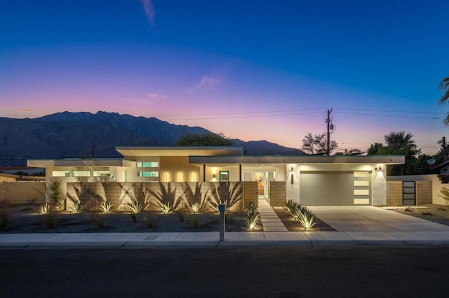 view of front facade featuring a mountain view and a garage