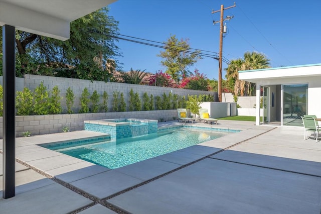 view of swimming pool featuring a patio area and an in ground hot tub