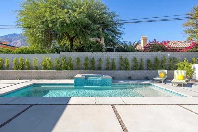 view of pool with a patio area, an in ground hot tub, and a mountain view