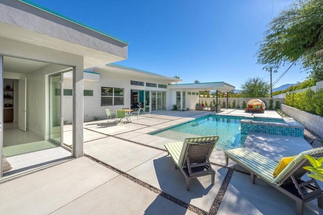 view of pool with a patio area and an in ground hot tub