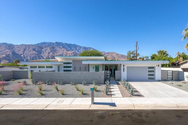 single story home featuring a mountain view and a garage