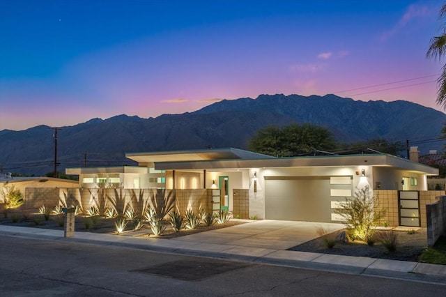 view of front of house with a mountain view and a garage