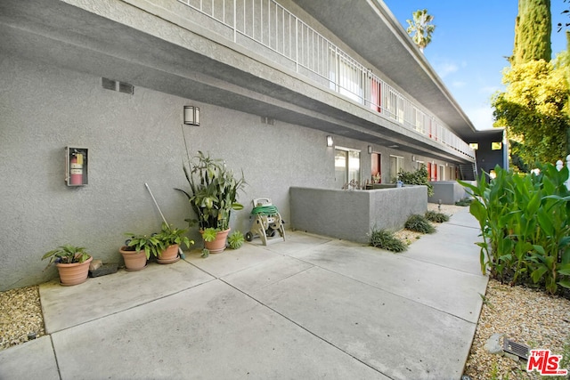 view of property exterior featuring a patio