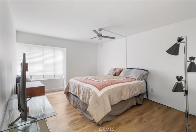 bedroom with ceiling fan and light hardwood / wood-style flooring