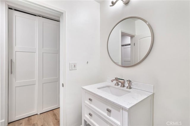 bathroom with hardwood / wood-style floors and vanity