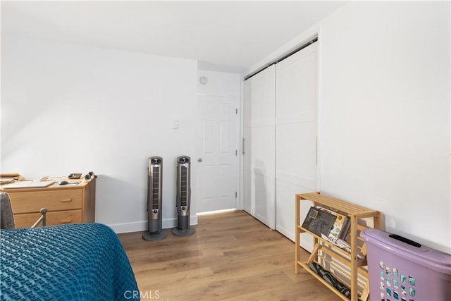 bedroom with hardwood / wood-style floors and a closet