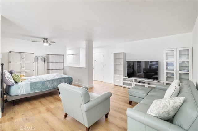 bedroom with ceiling fan and light hardwood / wood-style flooring