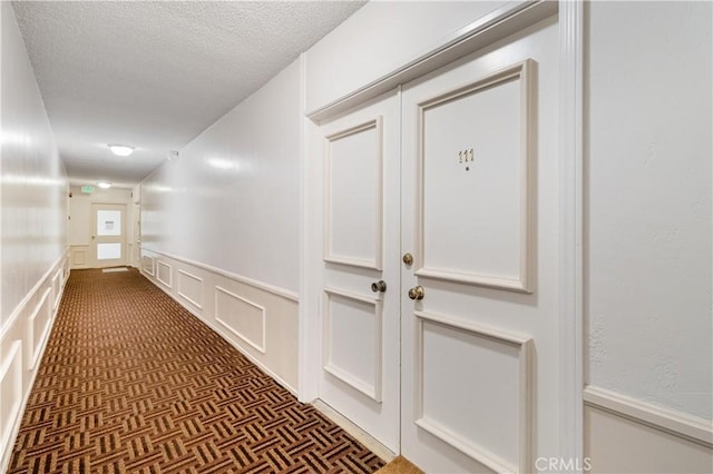 hallway featuring a textured ceiling