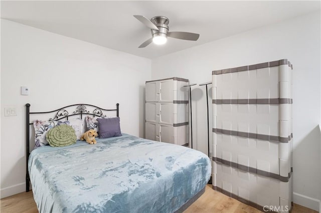 bedroom featuring ceiling fan and light hardwood / wood-style flooring