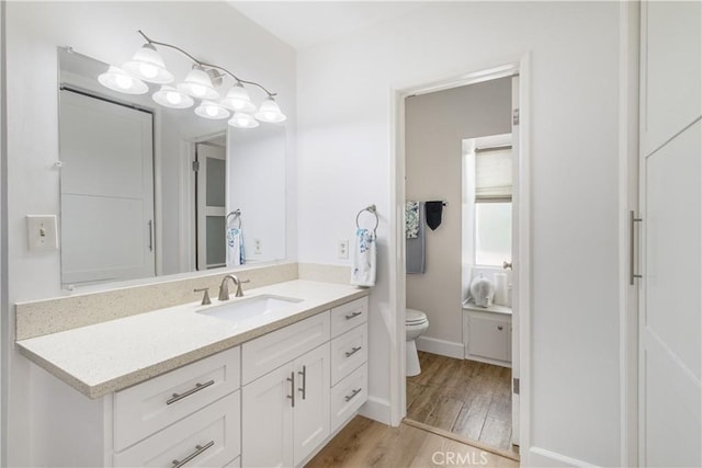 bathroom featuring hardwood / wood-style flooring, toilet, and vanity