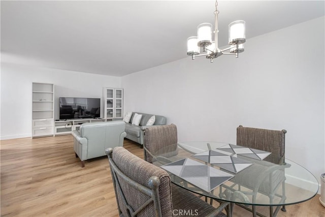 dining room featuring an inviting chandelier and light hardwood / wood-style floors