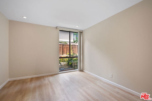 spare room with light wood-type flooring