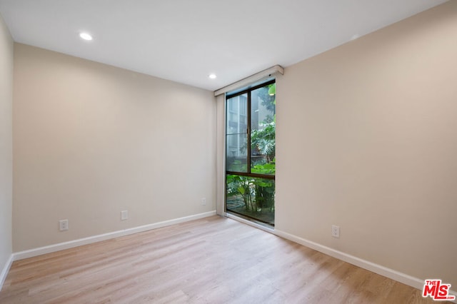 empty room with light hardwood / wood-style flooring