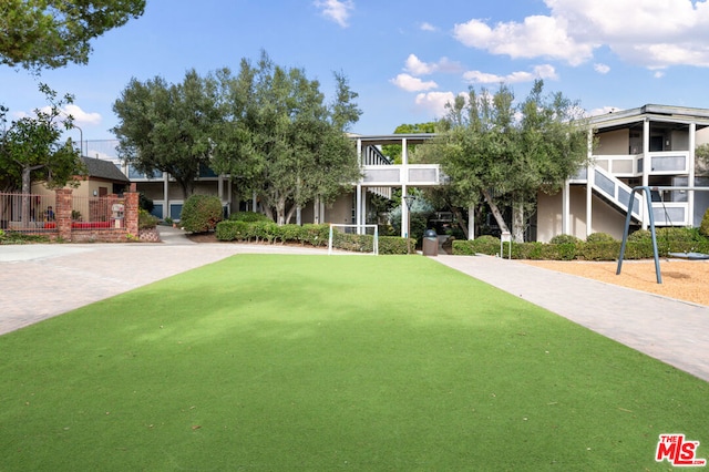 view of home's community featuring a lawn