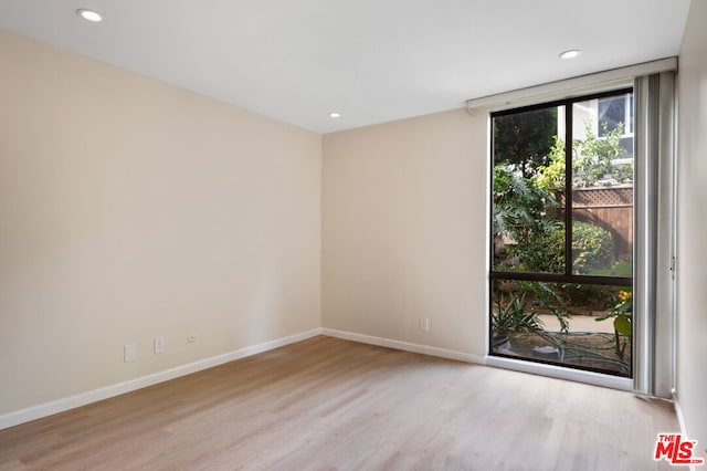 unfurnished room with light hardwood / wood-style floors