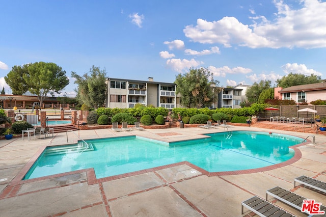 view of swimming pool with a patio area