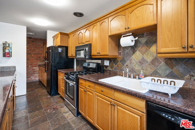 kitchen featuring sink, tasteful backsplash, and black appliances