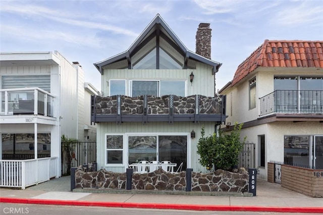 rear view of property with a balcony