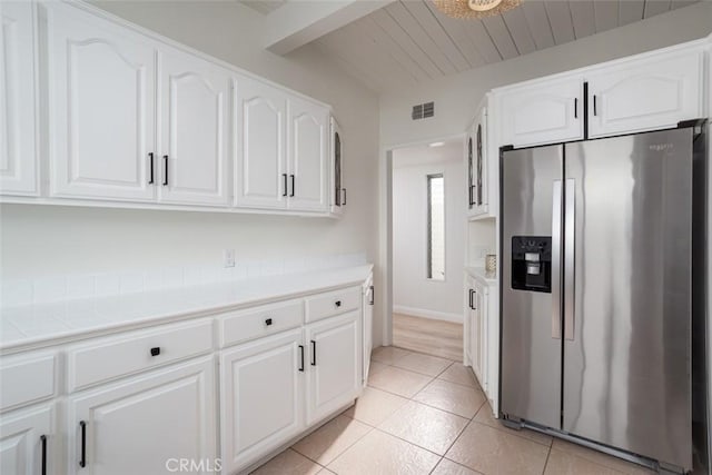 1809 W Bay Ave, Newport Beach, CA 92663 - kitchen with stainless steel fridge with ice dispenser, white cabinetry, and light tile patterned floors