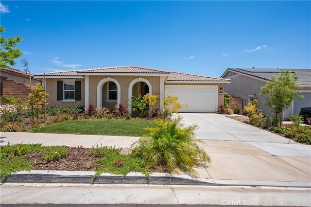 mediterranean / spanish-style home with a garage