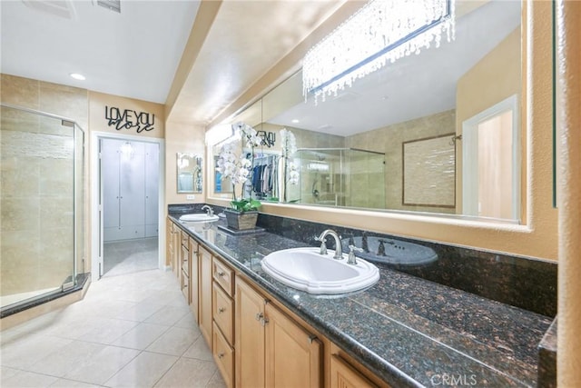 bathroom featuring tile patterned flooring, vanity, and a shower with shower door