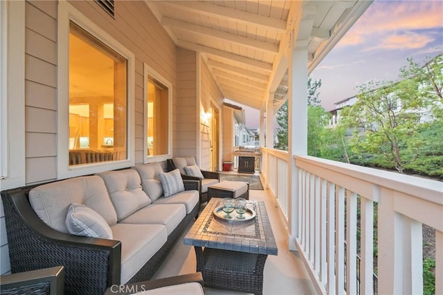 balcony at dusk with an outdoor hangout area