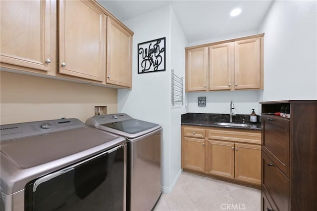 washroom featuring washer and clothes dryer, cabinets, and sink