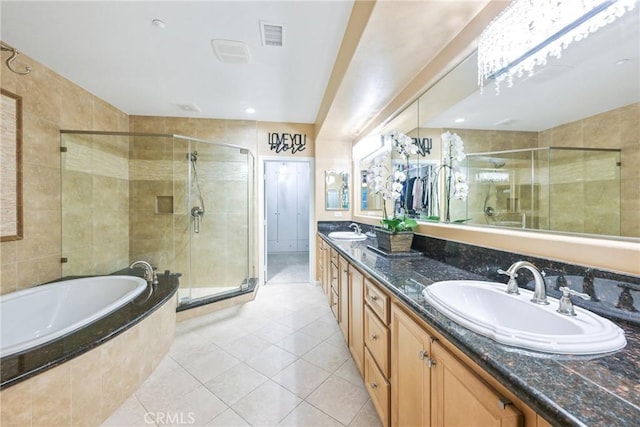 bathroom featuring plus walk in shower, tile patterned flooring, and vanity