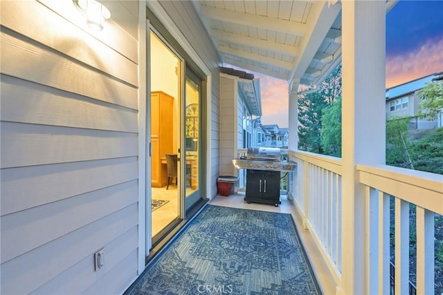 balcony at dusk with area for grilling