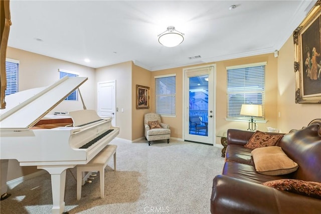 living area featuring light colored carpet and ornamental molding